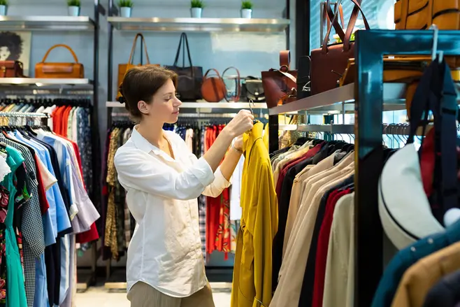 A woman looking at clothes in a store