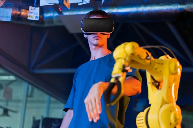 Człowiek w okularach VR sterujący ramieniem robota